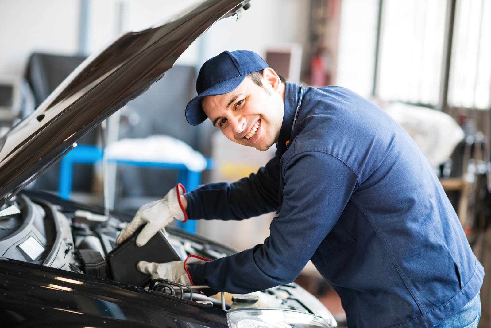 Mechanic repairing car in auto body shop near me