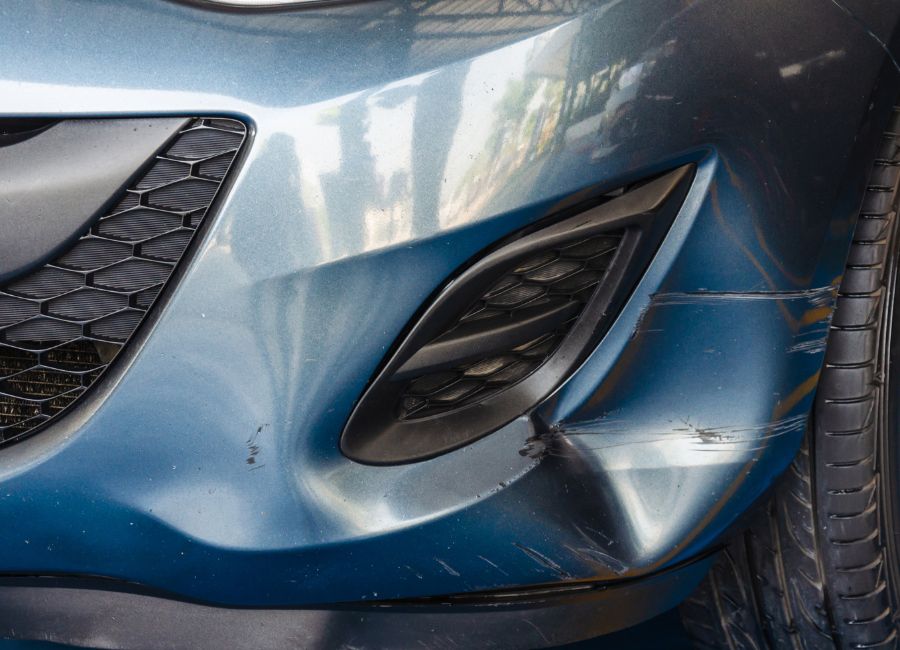 Car front bumper damaged, parked at Canwest collision center for bumper repair in Edmonton
