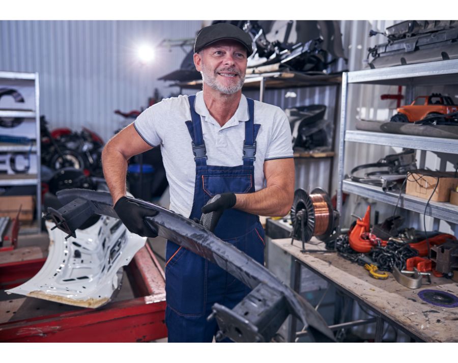 Mechanic repairing bumper on the desk Top Benefits of Choosing a Certified Collision Repair Center