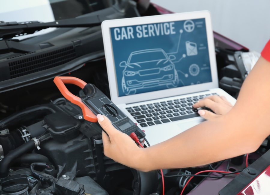 Computer connected to car for repair. Future of Collision Repair Tech, Sustainability, and Autonomy